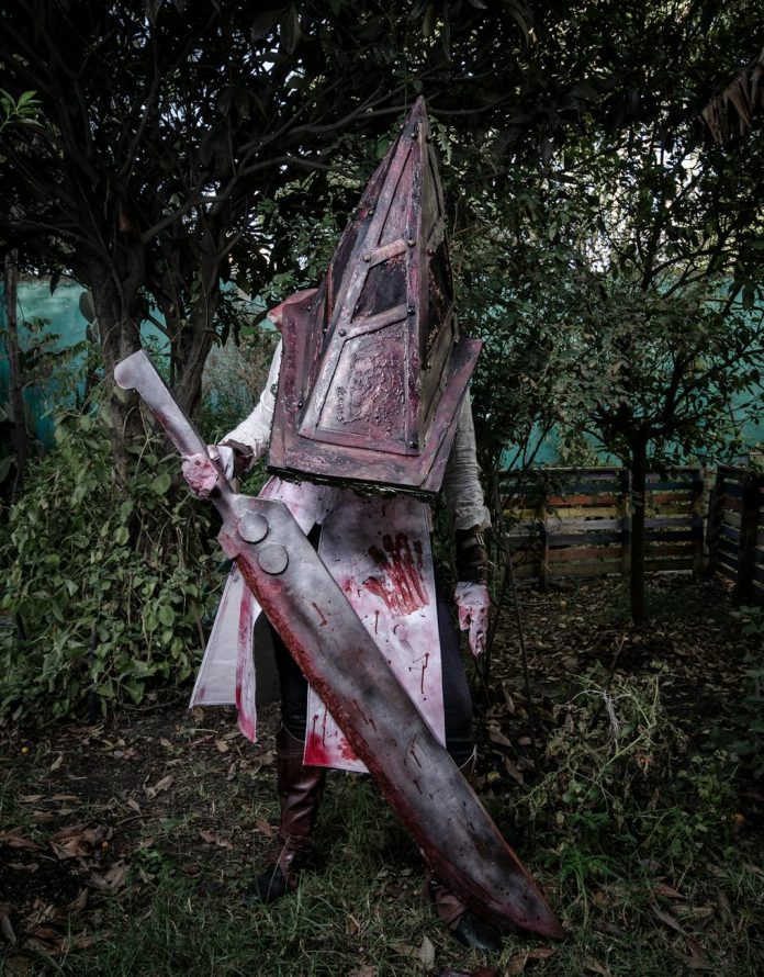 mysterious costumed character with large sword